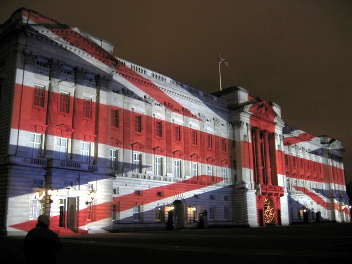 Buckingham Palace with a Union Jack projected onto it. Photograph taken by Michael Reeve, 24 December 2003